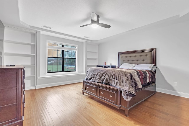 bedroom with baseboards, light wood finished floors, and ceiling fan