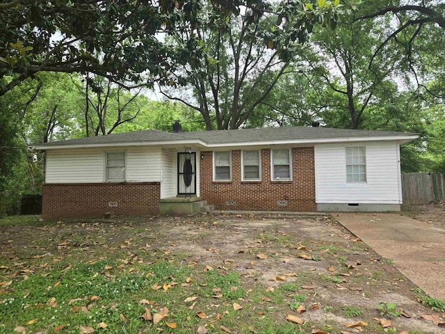 ranch-style home with crawl space, brick siding, and fence