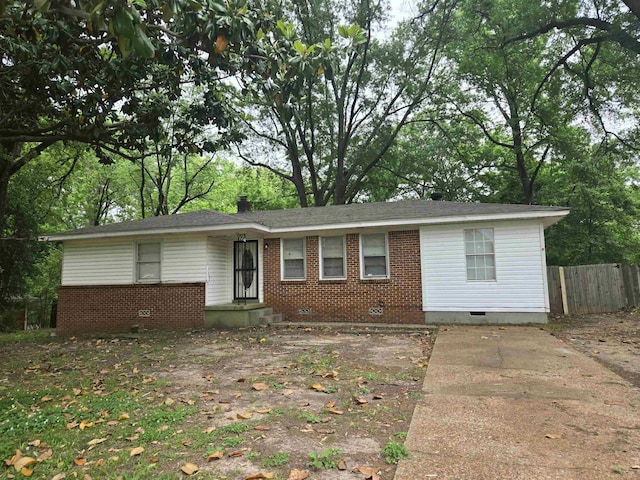 single story home with crawl space, brick siding, and fence