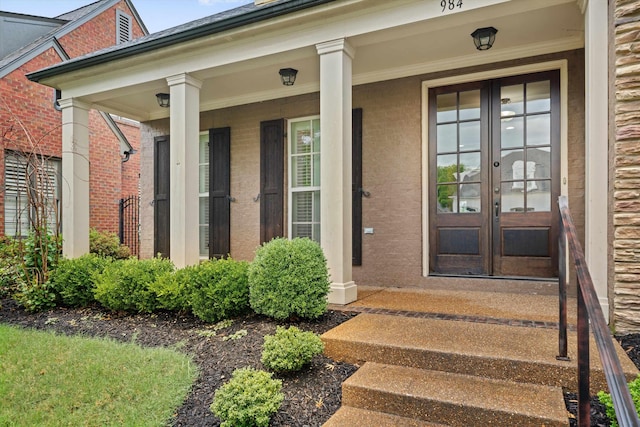 984 Russell Farms Rd, Collierville, TN 38017 - view of exterior entry with french doors, a porch, and brick siding