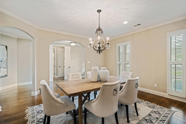 984 Russell Farms Rd, Collierville, TN 38017 - dining space featuring arched walkways, a chandelier, crown molding, baseboards, and dark wood-type flooring