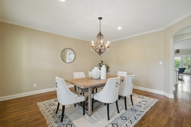 984 Russell Farms Rd, Collierville, TN 38017 - dining space with arched walkways, baseboards, a chandelier, wood finished floors, and ornamental molding