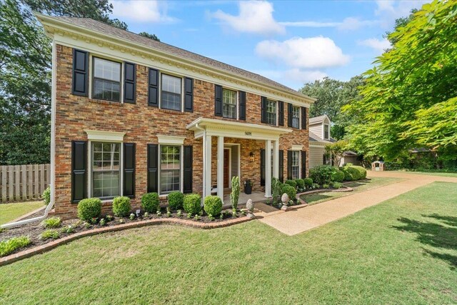 georgian-style home featuring brick siding