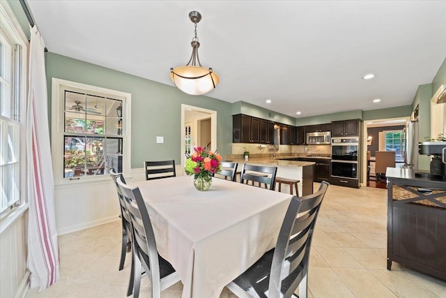 dining space with light tile patterned flooring and recessed lighting