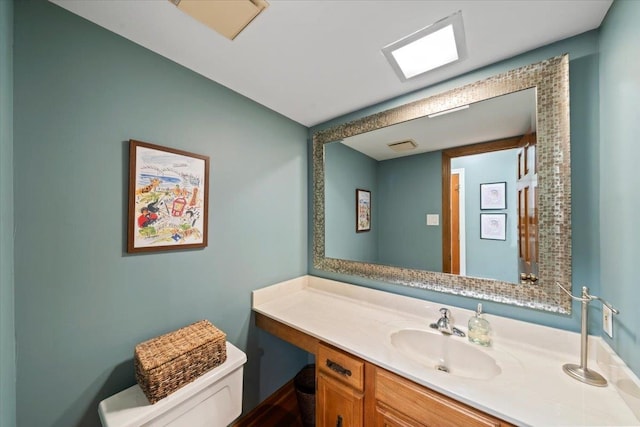 bathroom with toilet and vanity
