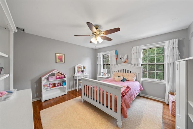 bedroom with wood finished floors, baseboards, and ceiling fan
