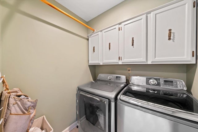 laundry room with cabinet space and washer and clothes dryer