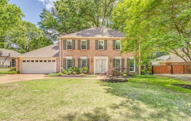 colonial home featuring concrete driveway, brick siding, a garage, and roof with shingles