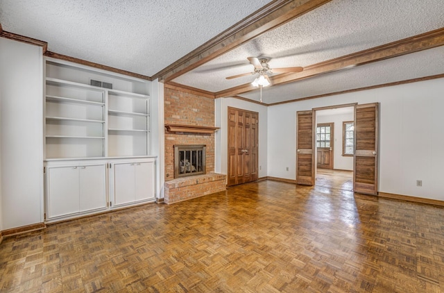 unfurnished living room with a textured ceiling, baseboards, a ceiling fan, a fireplace, and ornamental molding