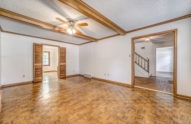 spare room featuring a textured ceiling, ceiling fan, baseboards, stairway, and ornamental molding