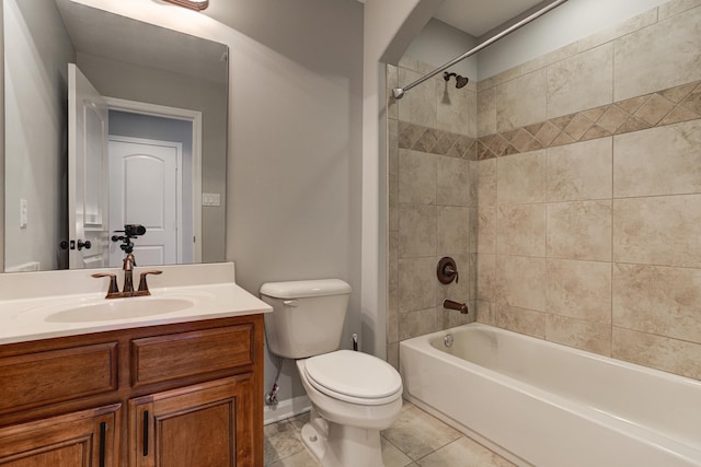 bathroom with toilet, vanity, tile patterned floors, shower / washtub combination, and baseboards