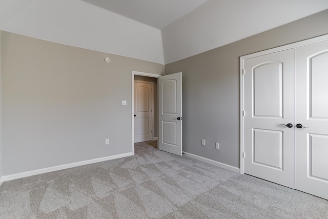 unfurnished bedroom with carpet flooring, baseboards, and a closet