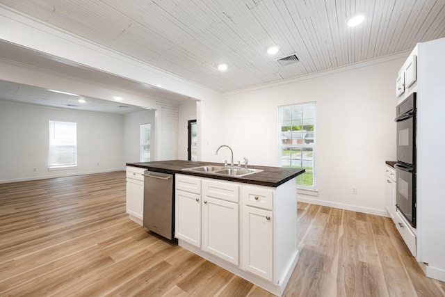 kitchen with a sink, stainless steel dishwasher, light wood-type flooring, healthy amount of natural light, and recessed lighting