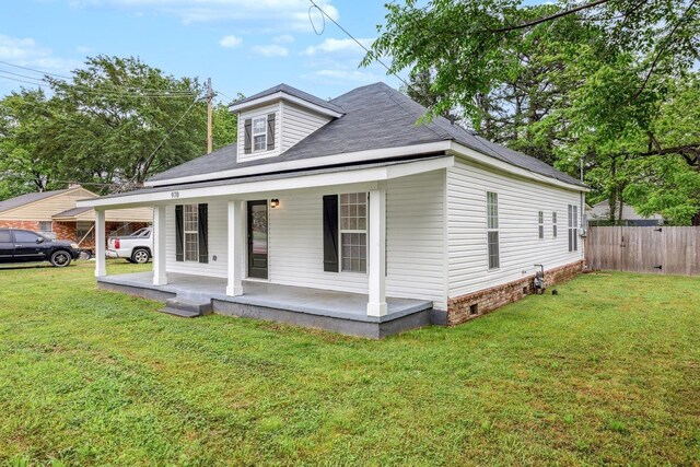 view of front of property featuring covered porch, a shingled roof, and a carport