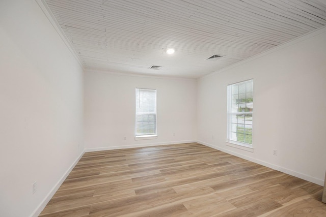 unfurnished room with crown molding, baseboards, and light wood finished floors