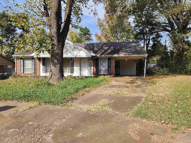 view of front of property featuring brick siding, concrete driveway, and a carport
