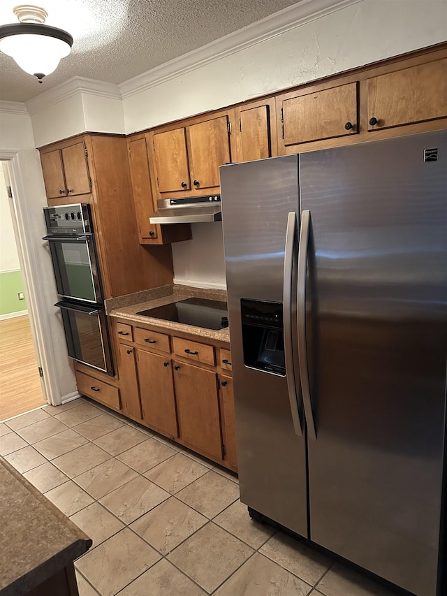 3236 Whitney Rd, Memphis, TN 38128 - kitchen featuring black appliances, under cabinet range hood, brown cabinets, crown molding, and light tile patterned floors
