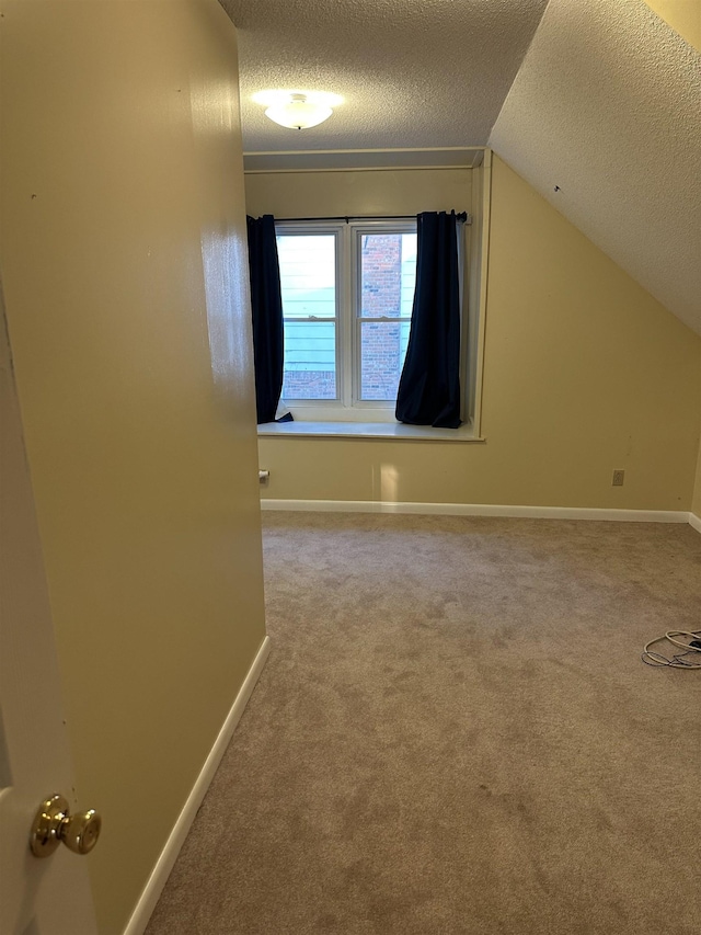 3236 Whitney Rd, Memphis, TN 38128 - additional living space with a textured ceiling, carpet flooring, lofted ceiling, and baseboards