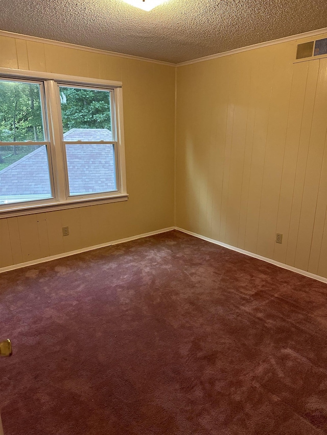 3236 Whitney Rd, Memphis, TN 38128 - spare room featuring a textured ceiling, dark carpet, and ornamental molding