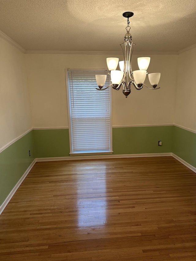 3236 Whitney Rd, Memphis, TN 38128 - unfurnished room with a textured ceiling, ornamental molding, wood finished floors, a chandelier, and baseboards