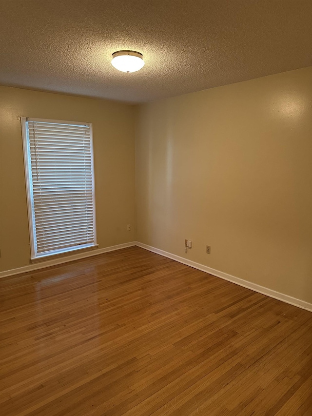 3236 Whitney Rd, Memphis, TN 38128 - empty room featuring wood finished floors, a textured ceiling, and baseboards