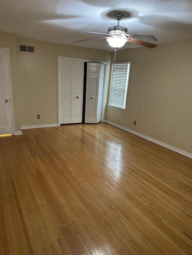 3236 Whitney Rd, Memphis, TN 38128 - unfurnished bedroom featuring baseboards, light wood-style floors, a closet, and a textured ceiling