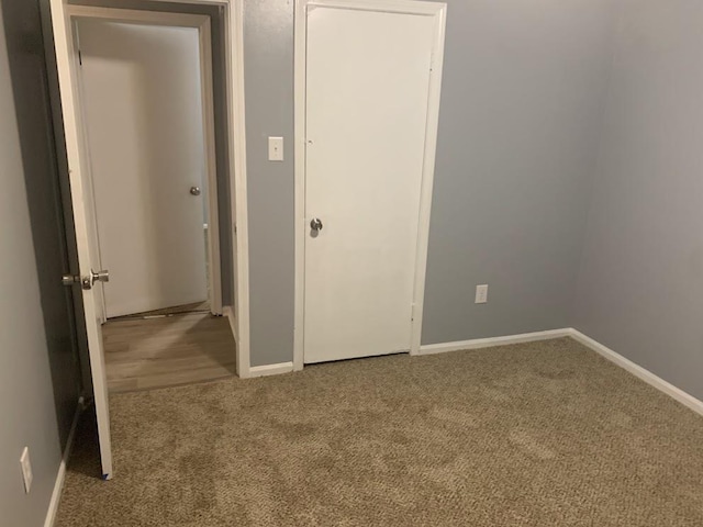 unfurnished bedroom with carpet and baseboards