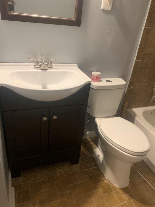 full bathroom with toilet and vanity