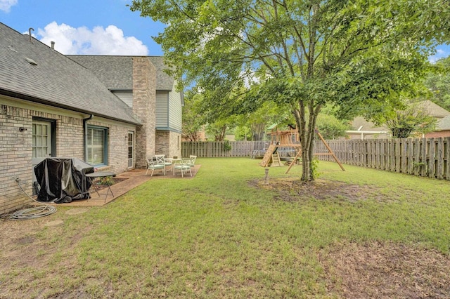 view of yard featuring a playground and a patio area