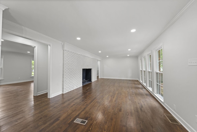 5516 Sycamore Grove Ln, Memphis, TN 38120 - unfurnished living room with healthy amount of natural light, dark wood-style floors, a brick fireplace, ornamental molding, and recessed lighting