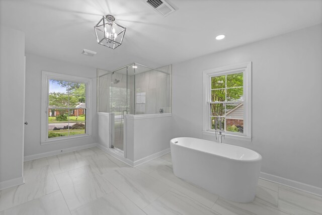 5516 Sycamore Grove Ln, Memphis, TN 38120 - full bathroom with marble finish flooring, baseboards, a shower stall, a freestanding tub, and recessed lighting