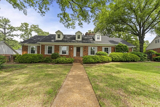 5516 Sycamore Grove Ln, Memphis, TN 38120 - new england style home featuring brick siding, a front yard, and roof with shingles