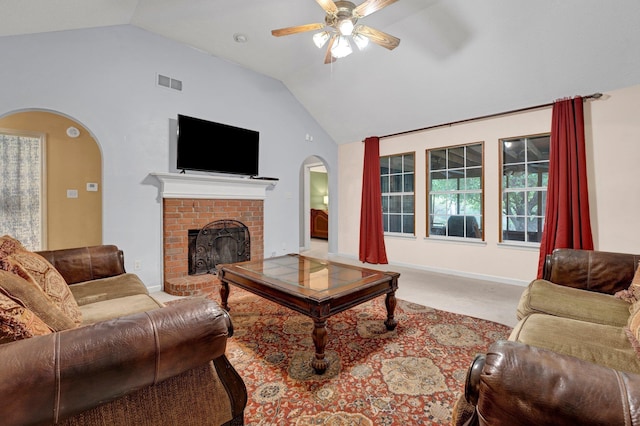 carpeted living room featuring arched walkways, lofted ceiling, a brick fireplace, a ceiling fan, and baseboards