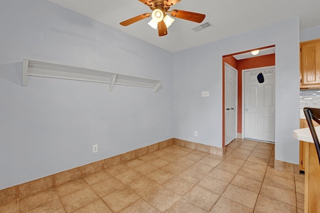 unfurnished room featuring a ceiling fan and light tile patterned floors