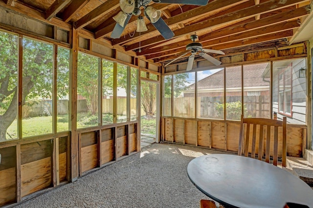 unfurnished sunroom featuring ceiling fan