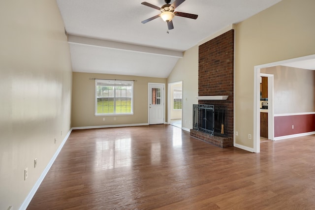 9669 Meadow Green Cv, Lakeland, TN 38002 - unfurnished living room with a ceiling fan, wood finished floors, a brick fireplace, beamed ceiling, and baseboards