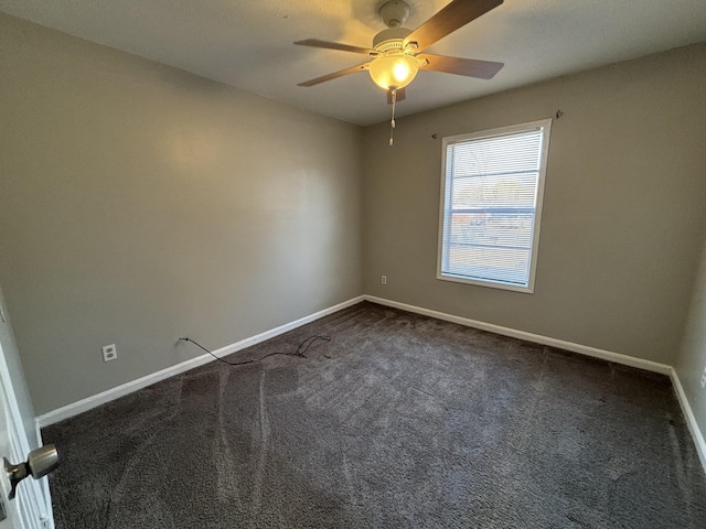 unfurnished room featuring dark colored carpet, baseboards, and ceiling fan