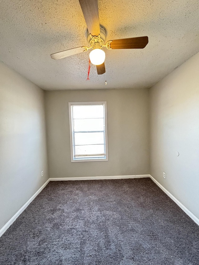 carpeted empty room featuring a textured ceiling, ceiling fan, and baseboards