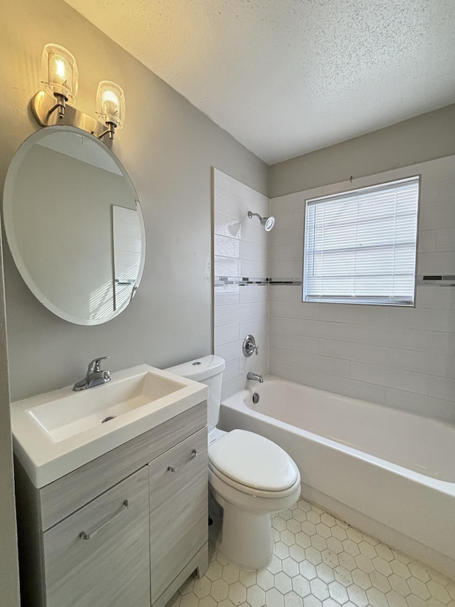 full bath featuring a textured ceiling, shower / tub combination, toilet, vanity, and tile patterned flooring