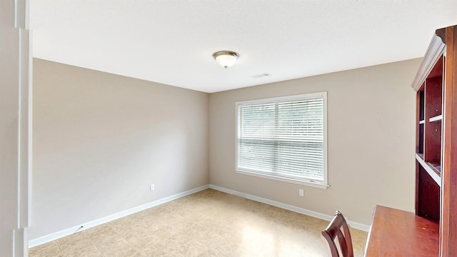 unfurnished office featuring baseboards