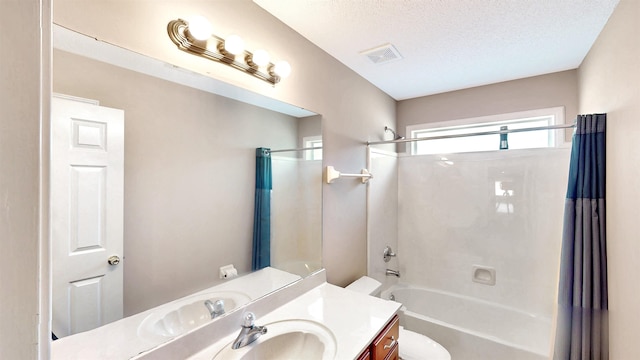 bathroom with toilet, shower / washtub combination, vanity, and a textured ceiling
