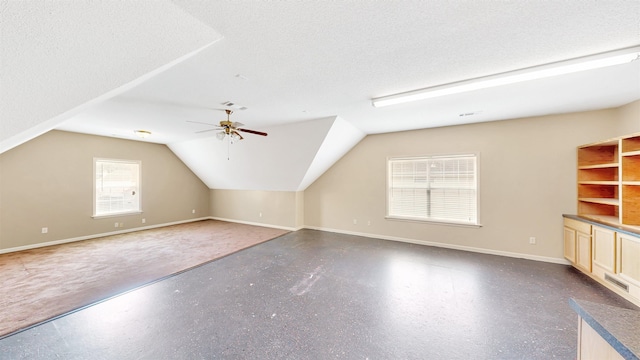 bonus room with baseboards, vaulted ceiling, and ceiling fan