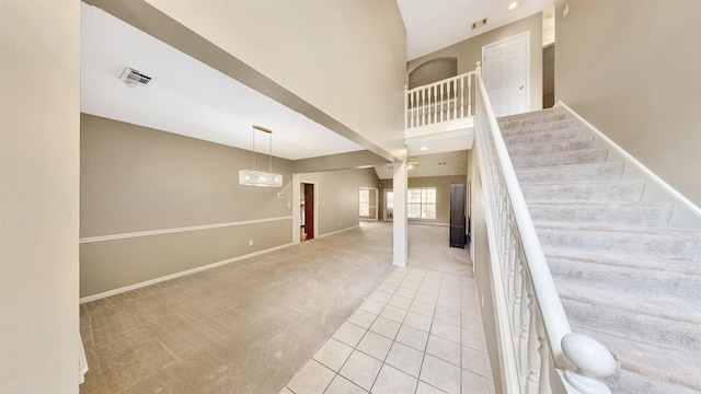 stairs featuring carpet floors, tile patterned floors, and baseboards