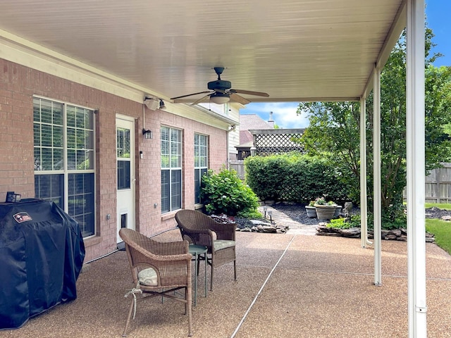 view of patio featuring a ceiling fan, area for grilling, and fence
