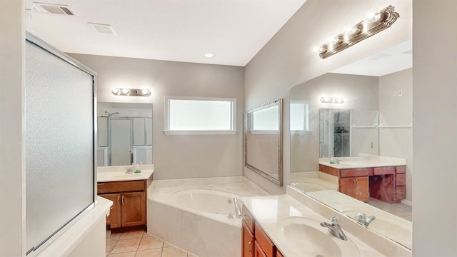 bathroom featuring a stall shower, a bath, tile patterned floors, and two vanities