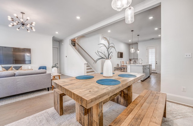 dining area featuring light wood-style flooring, stairway, baseboards, a chandelier, and recessed lighting