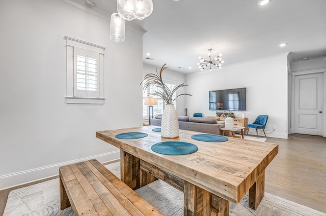 dining area with a chandelier, baseboards, recessed lighting, and light wood-style floors