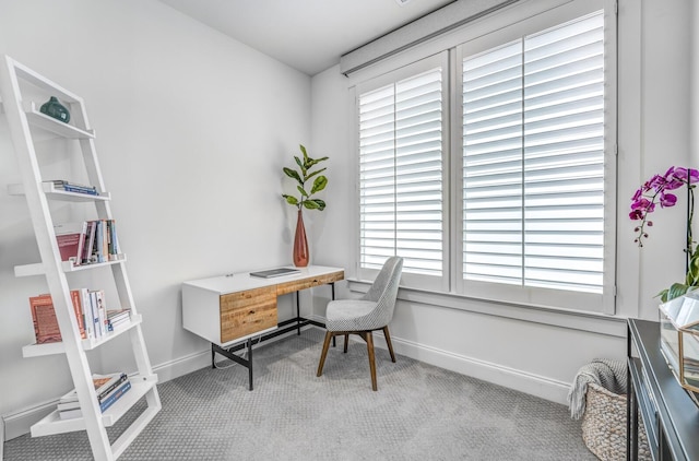 office space featuring carpet flooring, baseboards, and healthy amount of natural light