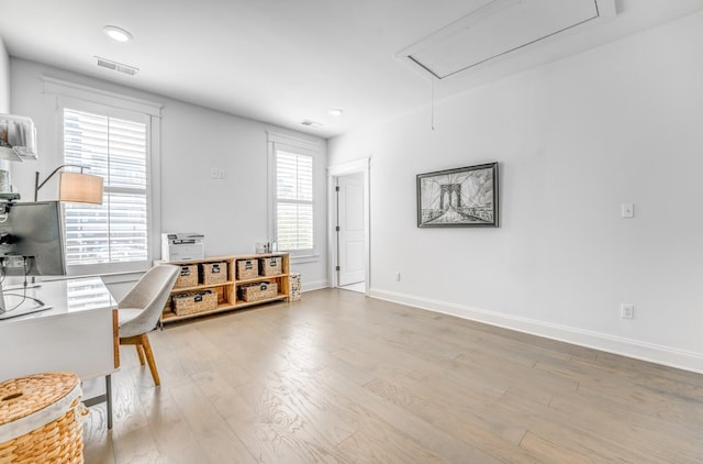 office featuring attic access, light wood-style floors, healthy amount of natural light, baseboards, and recessed lighting