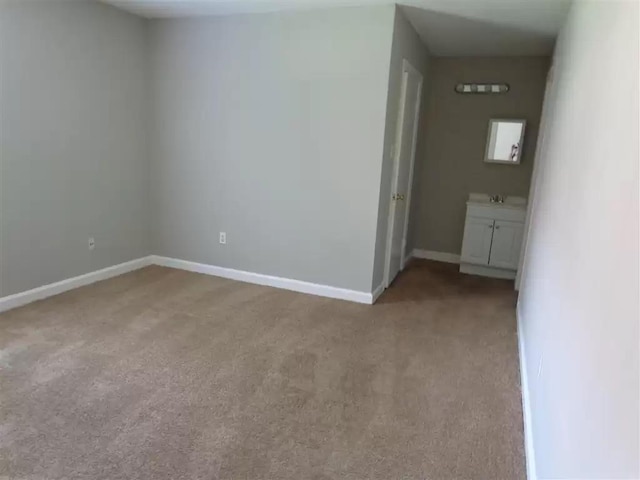3218 Thirteen Colony Mall Unit 1A, Memphis, TN 38115 - empty room with light colored carpet, baseboards, and a sink
